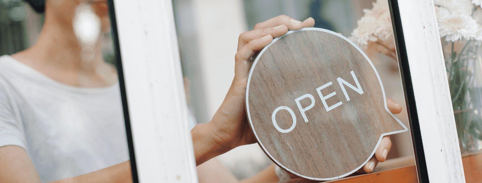 Stock photo: woman holding open sign in window