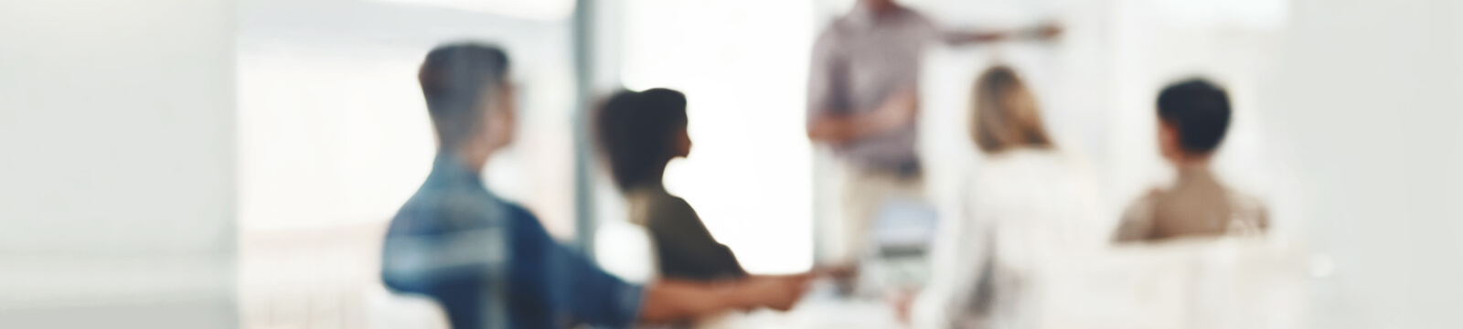 A blurred image of people in a meeting