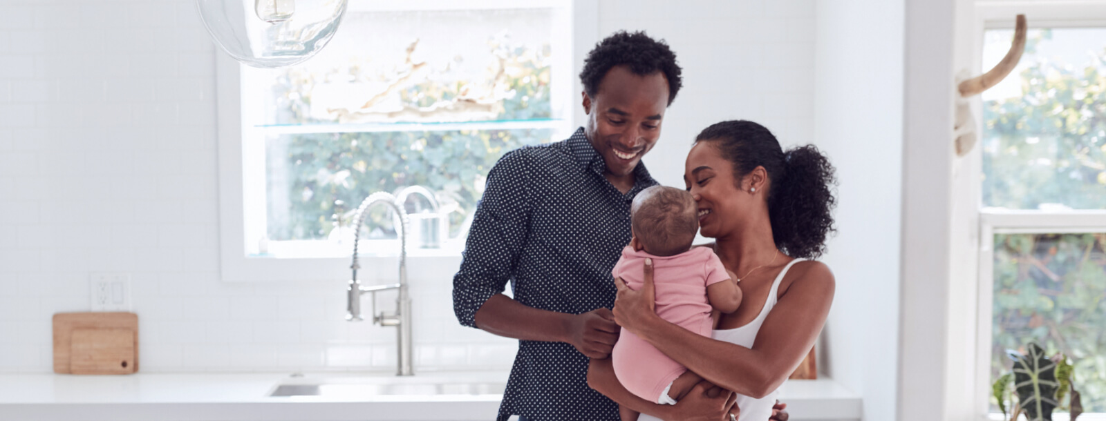 A young family smiling in kitchen